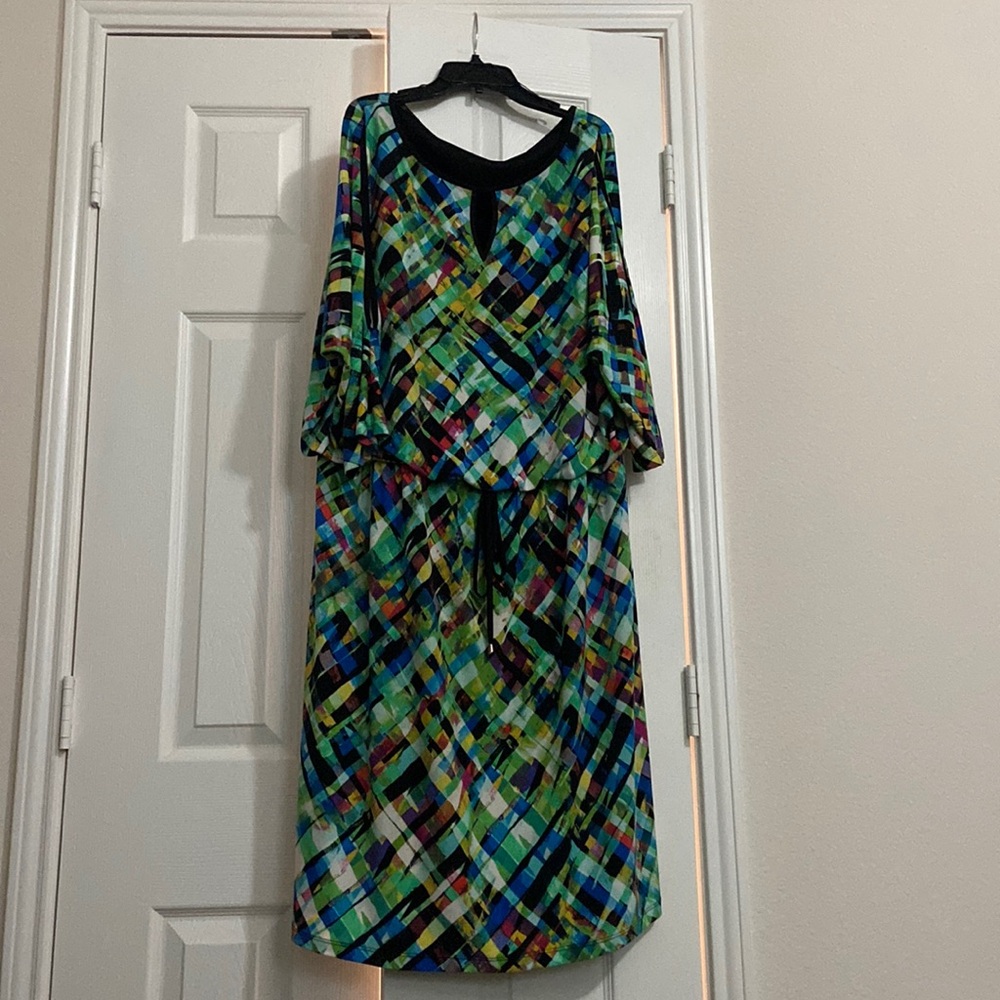 Colorful plus size dress with peep hole neckline and sleeves.